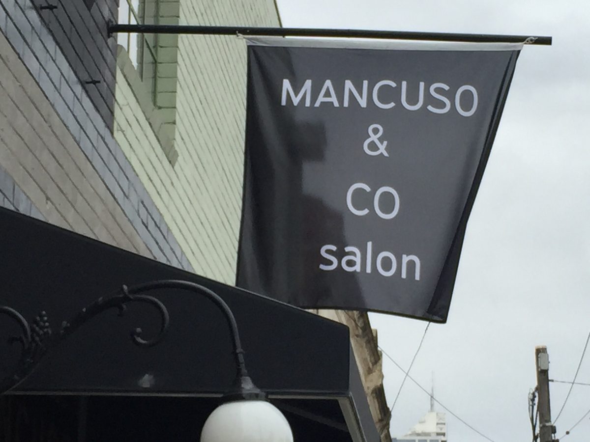 A black flag for MANCUSO & CO salon.