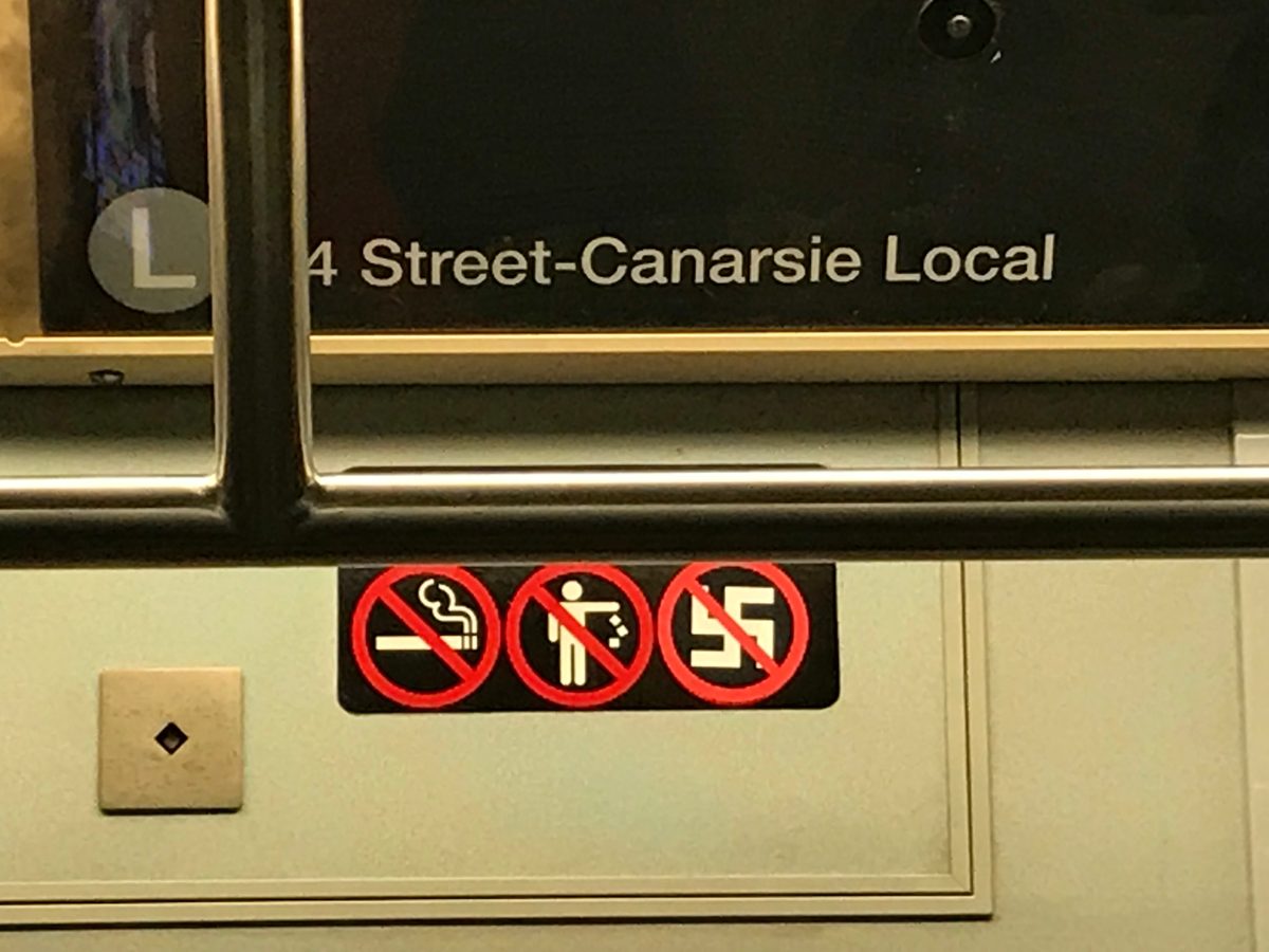 Train signage altered to read no smoking, no litter, no nazis