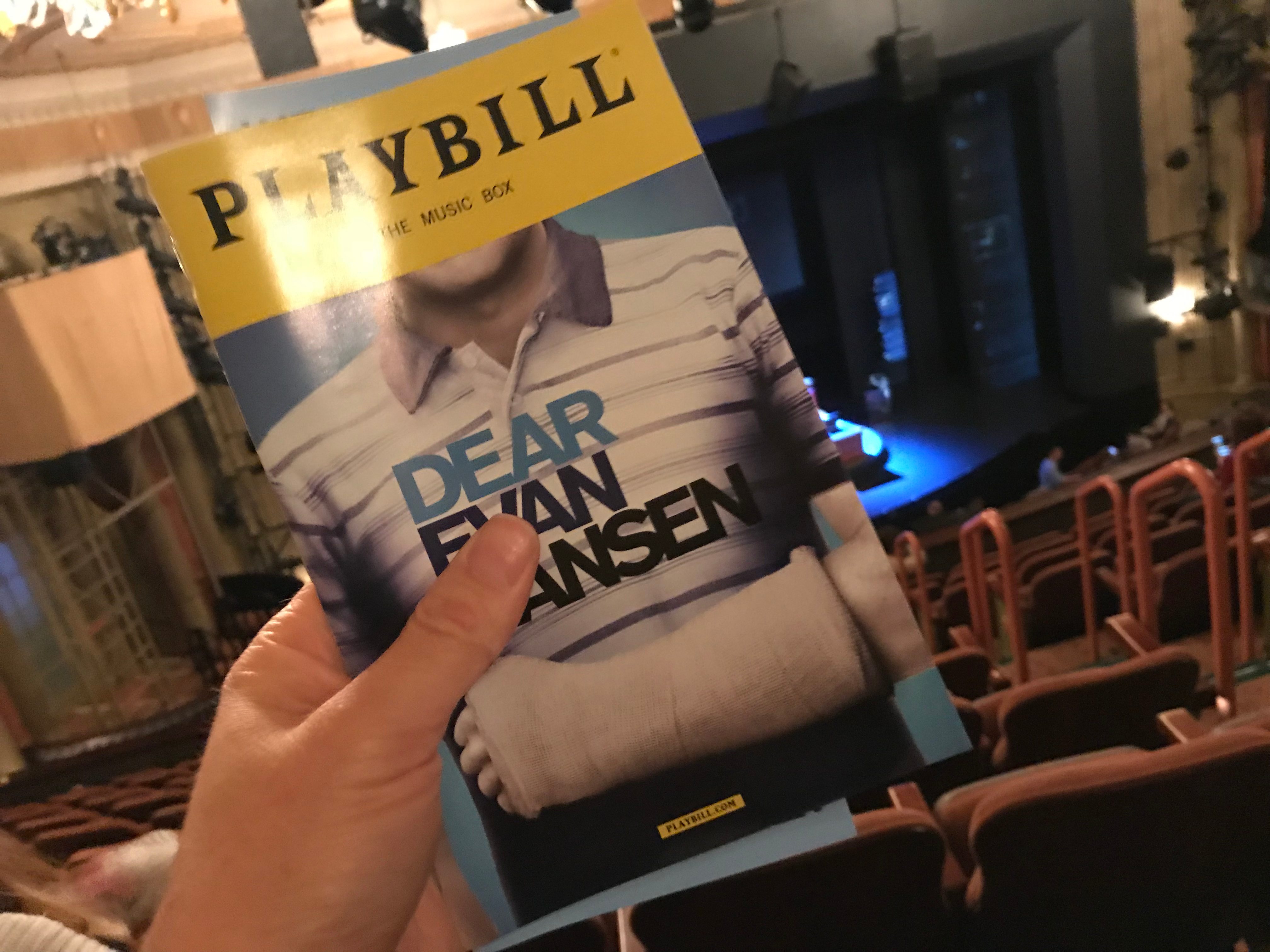 Dear Evan Hansen playbill in front of stage