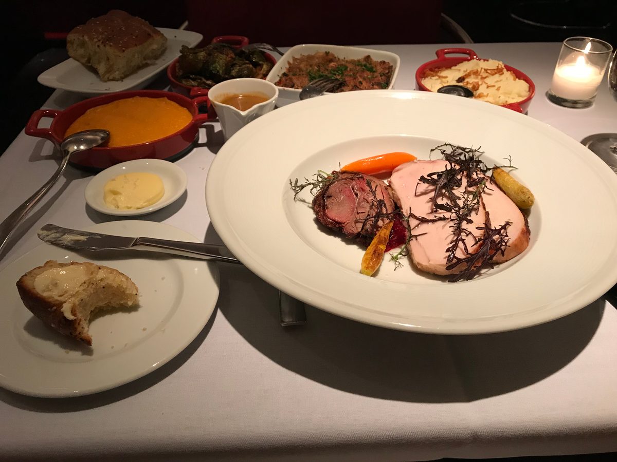 An ample supply of food with lamb cutlets and six sides