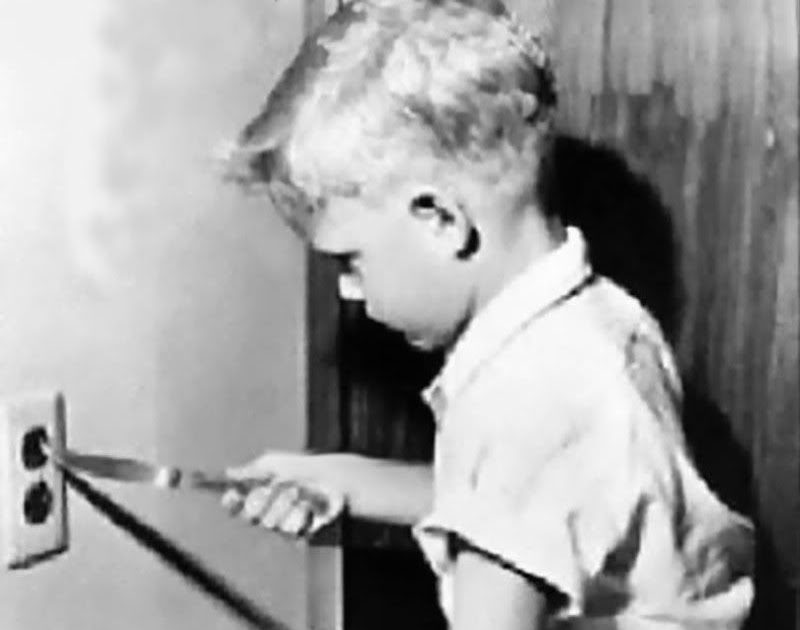 A young boy sticks a knife in an electrical socket