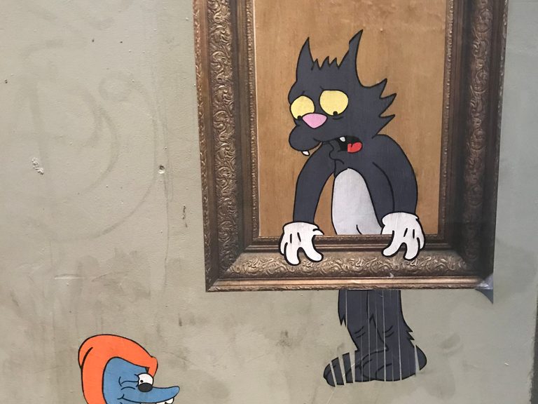A cat in a photo frame in the been shredded with a mouse looking on. The characters are in the style of Tom and Jerry.