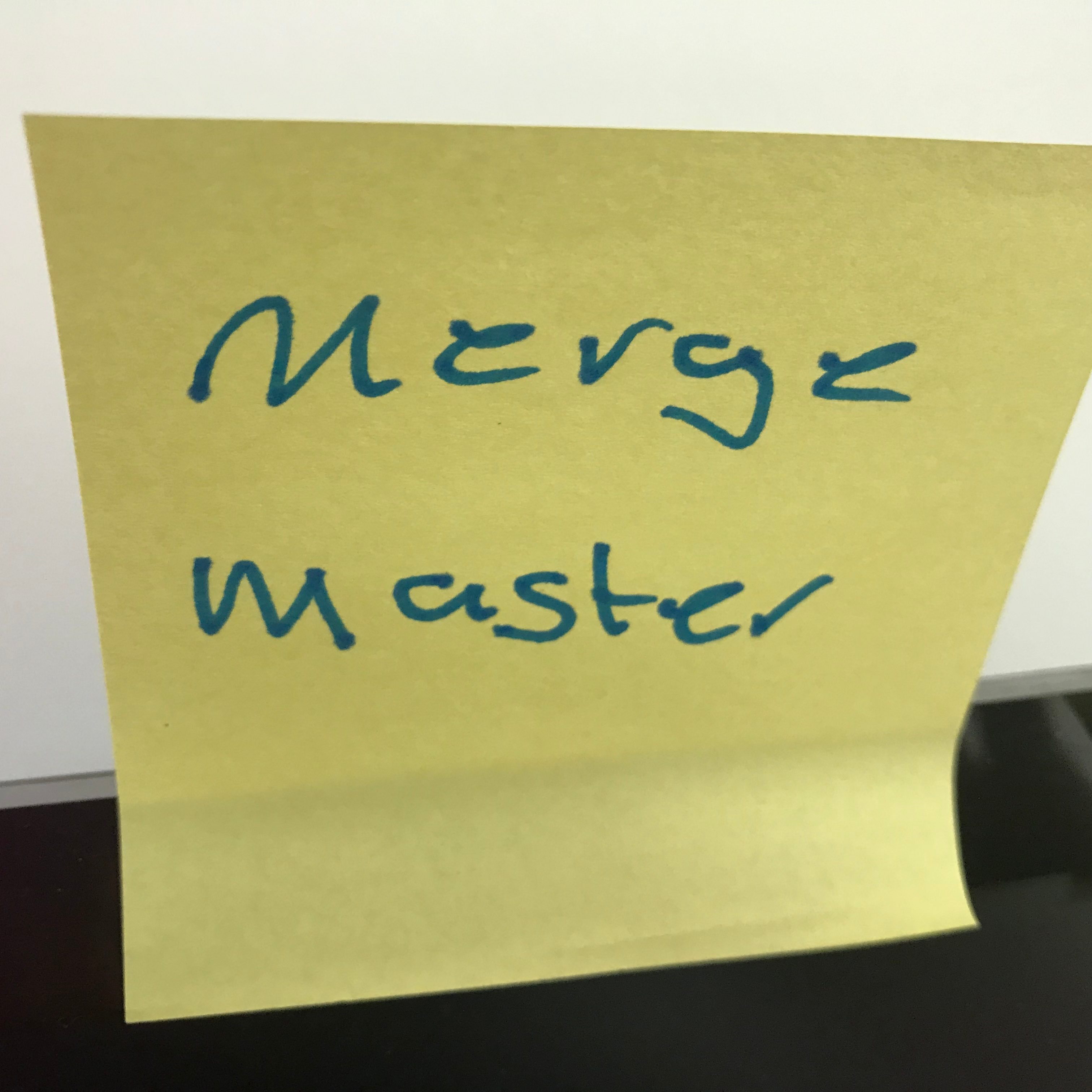 Post it note with the text "merge master"