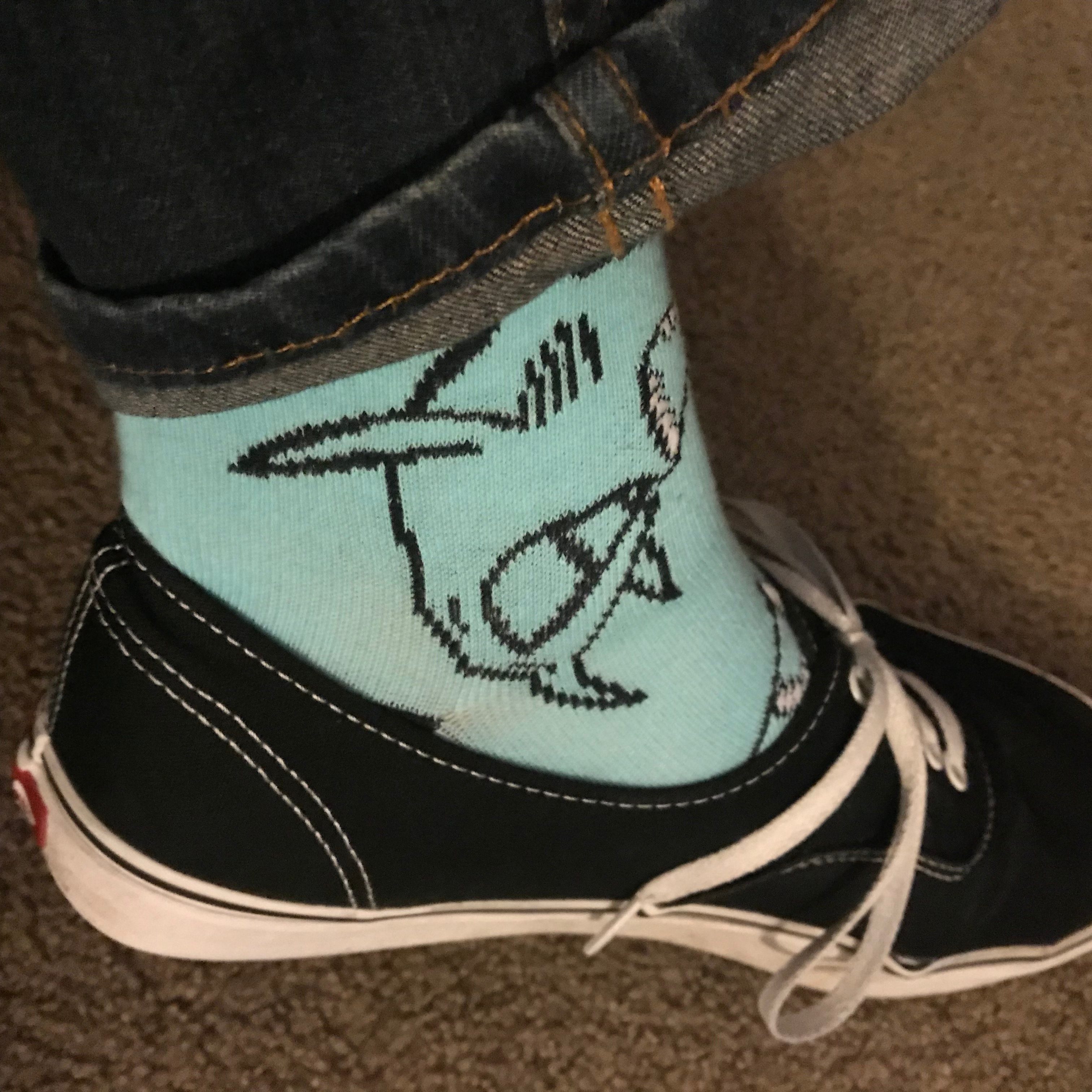 Ankle wearing cartoon shark print socks.