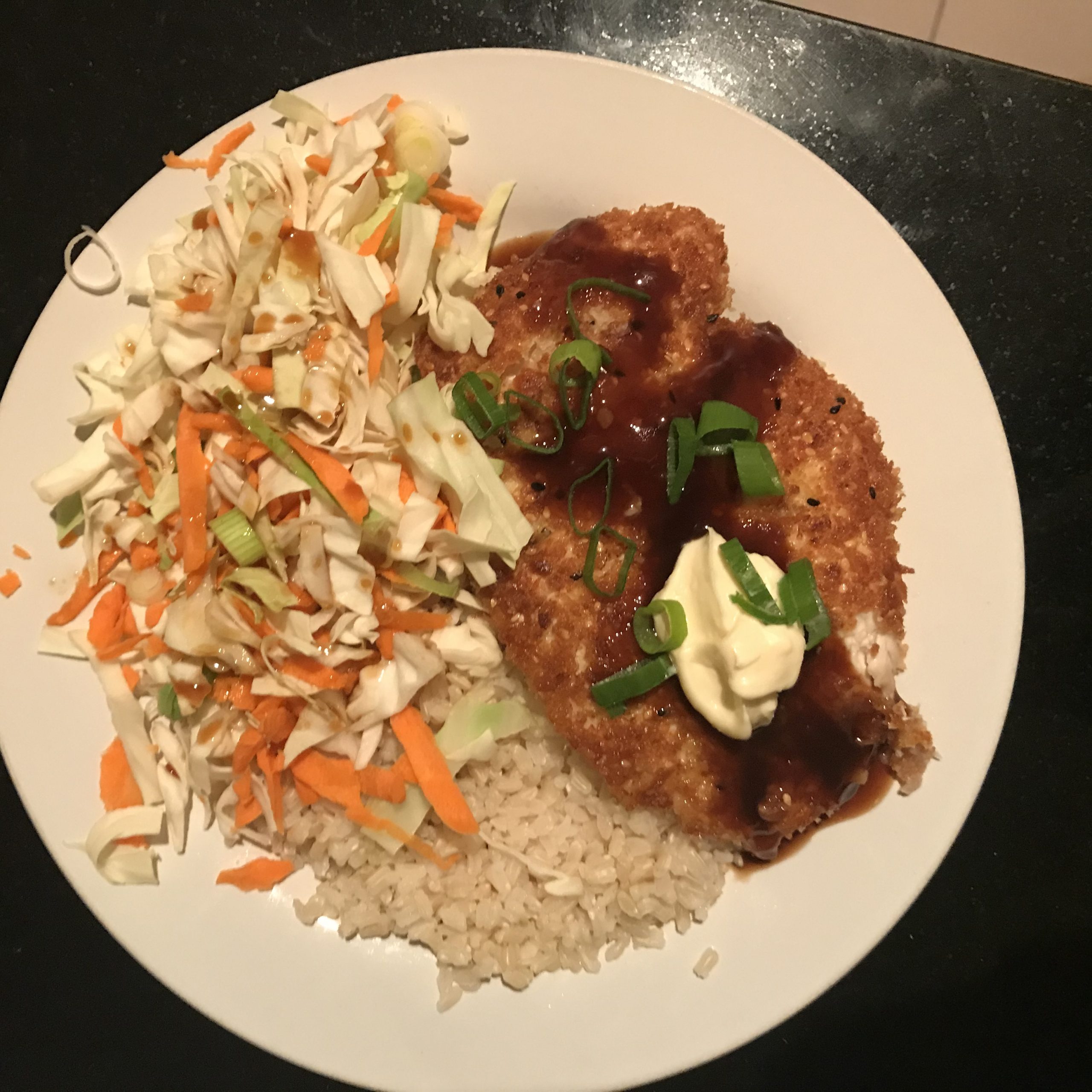 A meal of chicken, coleslaw and rice
