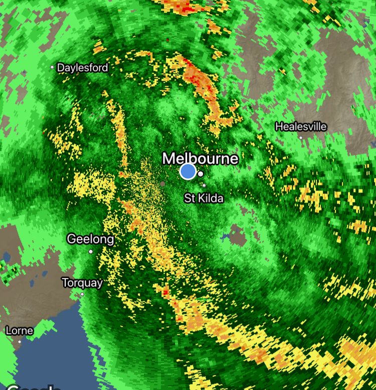 weather satellite showing a large patch of rain centred on a location marker.